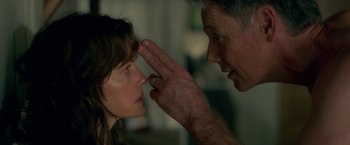 Movie still from “Gerald's Game” (2017), directed by Mike Flanagan – A man touching a woman's face with her hand; Close Up shot, Over the shoulder angle