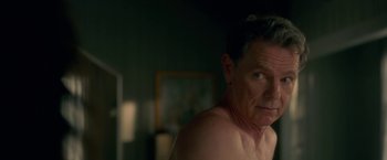 Movie still from “Gerald's Game” (2017), directed by Mike Flanagan – A shirtless man in a dark room looking at the camera; Close Up shot, Over the shoulder angle