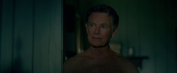 Movie still from “Gerald's Game” (2017), directed by Mike Flanagan – A shirtless man looking into a bathroom mirror; Close Up shot, Over the shoulder angle