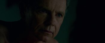 Movie still from “Gerald's Game” (2017), directed by Mike Flanagan – An older man with blue eyes stares into the camera; Close Up shot, Over the shoulder angle