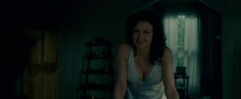 Movie still from “Gerald's Game” (2017), directed by Mike Flanagan – A woman in a nightgown smiling for the camera; Medium shot, Over the shoulder angle