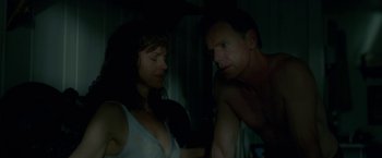 Movie still from “Gerald's Game” (2017), directed by Mike Flanagan – A man and a woman in a dark room looking at each other; Medium shot, Over the shoulder angle