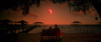 Movie still from “Gerald's Game” (2017), directed by Mike Flanagan – Two people sitting on a bench watching the sun go down; Extreme Wide shot, Over the shoulder angle