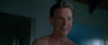 Movie still from “Gerald's Game” (2017), directed by Mike Flanagan – A person with no shirt smiling; Close Up shot, Over the shoulder angle