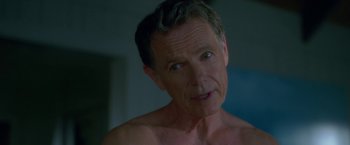 Movie still from “Gerald's Game” (2017), directed by Mike Flanagan – A shirtless man with no shirt looking at the camera; Close Up shot, Over the shoulder angle