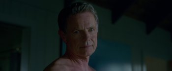 Movie still from “Gerald's Game” (2017), directed by Mike Flanagan – An older man is looking into the camera; Close Up shot, Over the shoulder angle