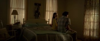 Movie still from “Gerald's Game” (2017), directed by Mike Flanagan – Two people are sitting on a bed in a bedroom; Wide shot, Low angle