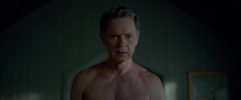 Movie still from “Gerald's Game” (2017), directed by Mike Flanagan – An older man with no shirt in a dark room; Close Up shot, Over the shoulder angle