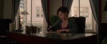Movie still from “Gerald's Game” (2017), directed by Mike Flanagan – A woman sitting at a table writing on a piece of paper; Medium shot, High angle
