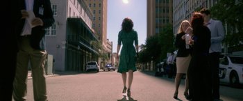 Movie still from “Gerald's Game” (2017), directed by Mike Flanagan – A woman in a green dress is walking down the street; Wide shot, Low angle