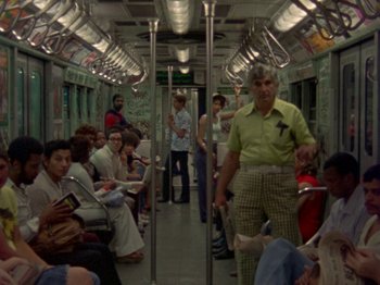 A group of people sitting on a subway train