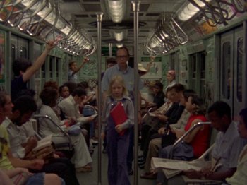 A group of people riding on a subway train
