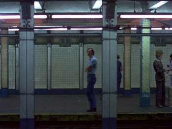 A man standing on a train platform in a train station