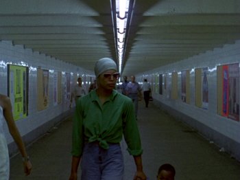 A man walking down a hallway in a tunnel