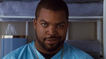 Movie still from “Next Friday” (2000), directed by Steve Carr – A person wearing a blue shirt; Close Up shot, Low angle