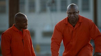 Movie still from “Next Friday” (2000), directed by Steve Carr – A couple of men standing next to each other; Medium shot, Low angle