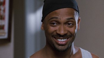 Movie still from “Next Friday” (2000), directed by Steve Carr – A person wearing a black hat; Close Up shot, Over the shoulder angle