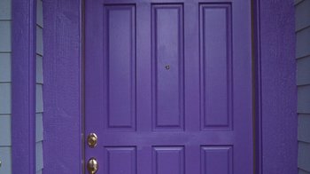 Movie still from “Next Friday” (2000), directed by Steve Carr – View of a purple door with four panes; Wide shot, High angle