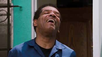 Movie still from “Next Friday” (2000), directed by Steve Carr – A person laughing with his eyes closed; Close Up shot, Low angle