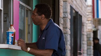 Movie still from “Next Friday” (2000), directed by Steve Carr – A man standing in front of a window; Medium shot, Over the shoulder angle