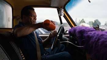 Movie still from “Next Friday” (2000), directed by Steve Carr – A man sitting in the driver's seat of a car; Medium shot, Low angle