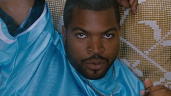 Movie still from “Next Friday” (2000), directed by Steve Carr – A person wearing a blue shirt; Close Up shot, Low angle