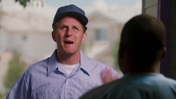 Movie still from “Next Friday” (2000), directed by Steve Carr – A man wearing a blue hat talking to another man; Close Up shot, Over the shoulder angle
