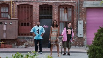 Movie still from “Next Friday” (2000), directed by Steve Carr – A group of people standing on the side of the street; Wide shot, Low angle