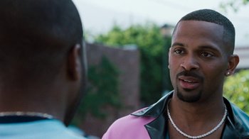 Movie still from “Next Friday” (2000), directed by Steve Carr – A man wearing a pink jacket talking to another man; Close Up shot, Over the shoulder angle