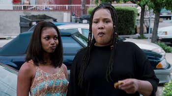 Movie still from “Next Friday” (2000), directed by Steve Carr – Two women standing next to each other on the street; Medium shot, Over the shoulder angle