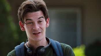 Movie still from “Next Friday” (2000), directed by Steve Carr – A young man wearing headphones and looking at the camera; Close Up shot, Over the shoulder angle