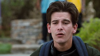 Movie still from “Next Friday” (2000), directed by Steve Carr – A young man with headphones is sitting outside; Close Up shot, Over the shoulder angle