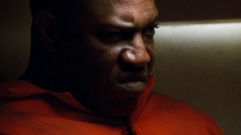 Movie still from “Next Friday” (2000), directed by Steve Carr – A person wearing an orange shirt; Close Up shot, Low angle