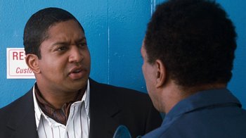Movie still from “Next Friday” (2000), directed by Steve Carr – Two men talking to each other in front of a blue wall; Close Up shot, Over the shoulder angle