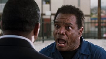 Movie still from “Next Friday” (2000), directed by Steve Carr – A man with his mouth wide open talking to another man; Close Up shot, Low angle