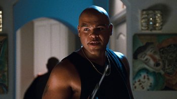 Movie still from “Next Friday” (2000), directed by Steve Carr – A man with a shaved head is posing for a picture; Close Up shot, Low angle