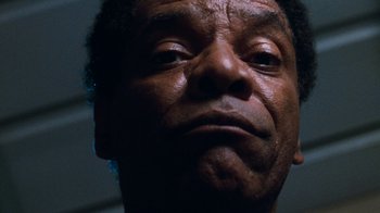 Movie still from “Next Friday” (2000), directed by Steve Carr – A person's face in the dark; Extreme Close Up shot, Low angle