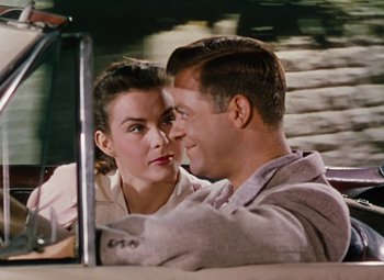 Movie still from “Niagara” (1953), directed by Henry Hathaway – A man and a woman sitting in front of a laptop computer; Close Up shot, Over the shoulder angle