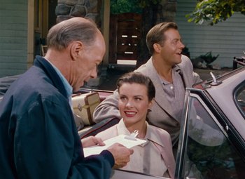 Movie still from “Niagara” (1953), directed by Henry Hathaway – A man standing next to a woman in the back of a car; Medium shot, High angle