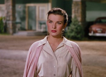 Movie still from “Niagara” (1953), directed by Henry Hathaway – A woman in a white shirt and a pink jacket; Medium shot, Low angle