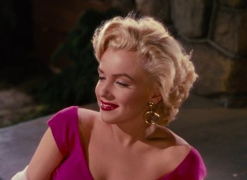 Movie still from “Niagara” (1953), directed by Henry Hathaway – A woman with blonde hair wearing a pink dress; Close Up shot, Over the shoulder angle