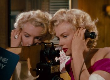 Movie still from “Niagara” (1953), directed by Henry Hathaway – A woman is taking a picture of herself in the mirror; Medium shot, High angle