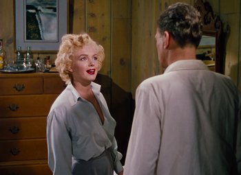 Movie still from “Niagara” (1953), directed by Henry Hathaway – A woman standing next to a man in front of a dresser; Medium shot, Over the shoulder angle