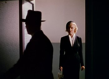 Movie still from “Niagara” (1953), directed by Henry Hathaway – A man and a woman in a suit and tie; Medium shot, Low angle