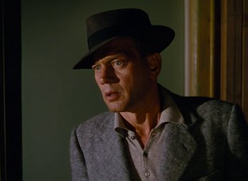 Movie still from “Niagara” (1953), directed by Henry Hathaway – A man wearing a hat and a jacket; Close Up shot, Over the shoulder angle
