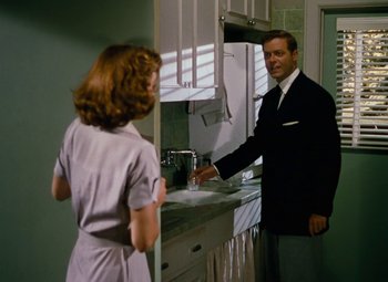 Movie still from “Niagara” (1953), directed by Henry Hathaway – A man and a woman in a kitchen with a sink; Medium shot, Over the shoulder angle