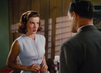 Movie still from “Niagara” (1953), directed by Henry Hathaway – A woman and a man are talking in a room; Medium shot, Over the shoulder angle