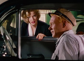 Movie still from “Niagara” (1953), directed by Henry Hathaway – A man and a woman sitting in the back of a car; Medium shot, Over the shoulder angle
