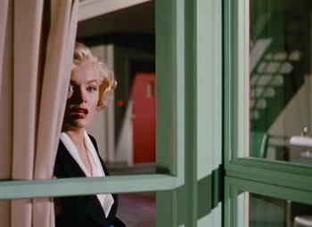 Movie still from “Niagara” (1953), directed by Henry Hathaway – A woman standing in front of an open window; Medium shot, Low angle