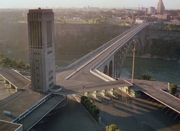 Movie still from “Niagara” (1953), directed by Henry Hathaway – An aerial view of a bridge and a building; Extreme Wide shot, High angle